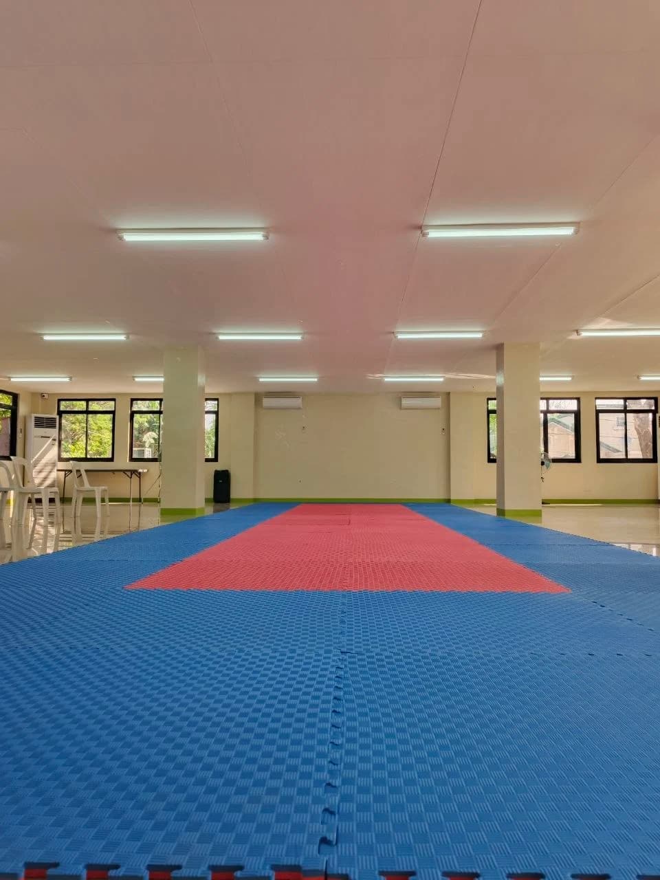The training hall matted out in blue and red, ready for class