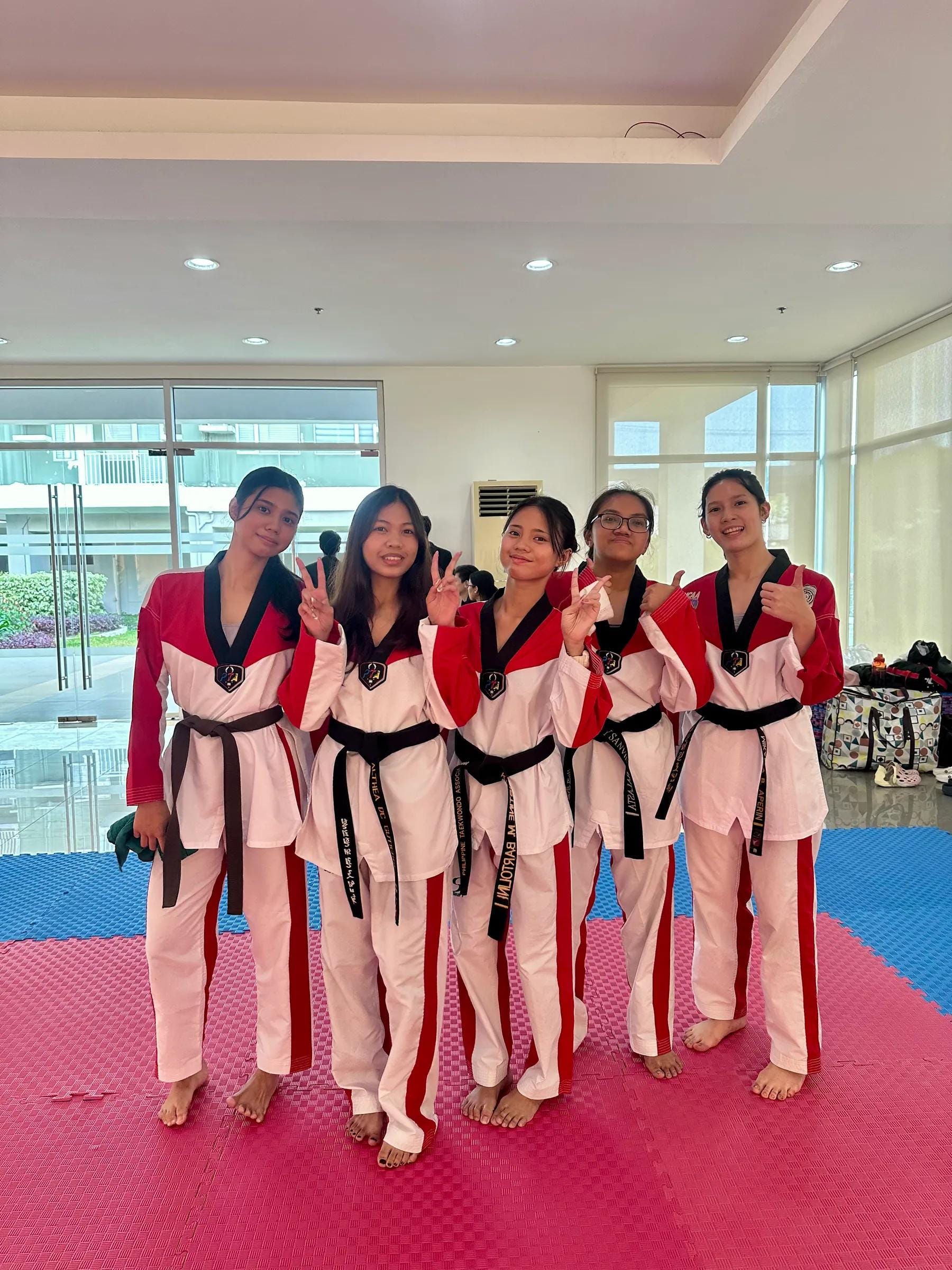 Teen students in black-belt doboks standing together