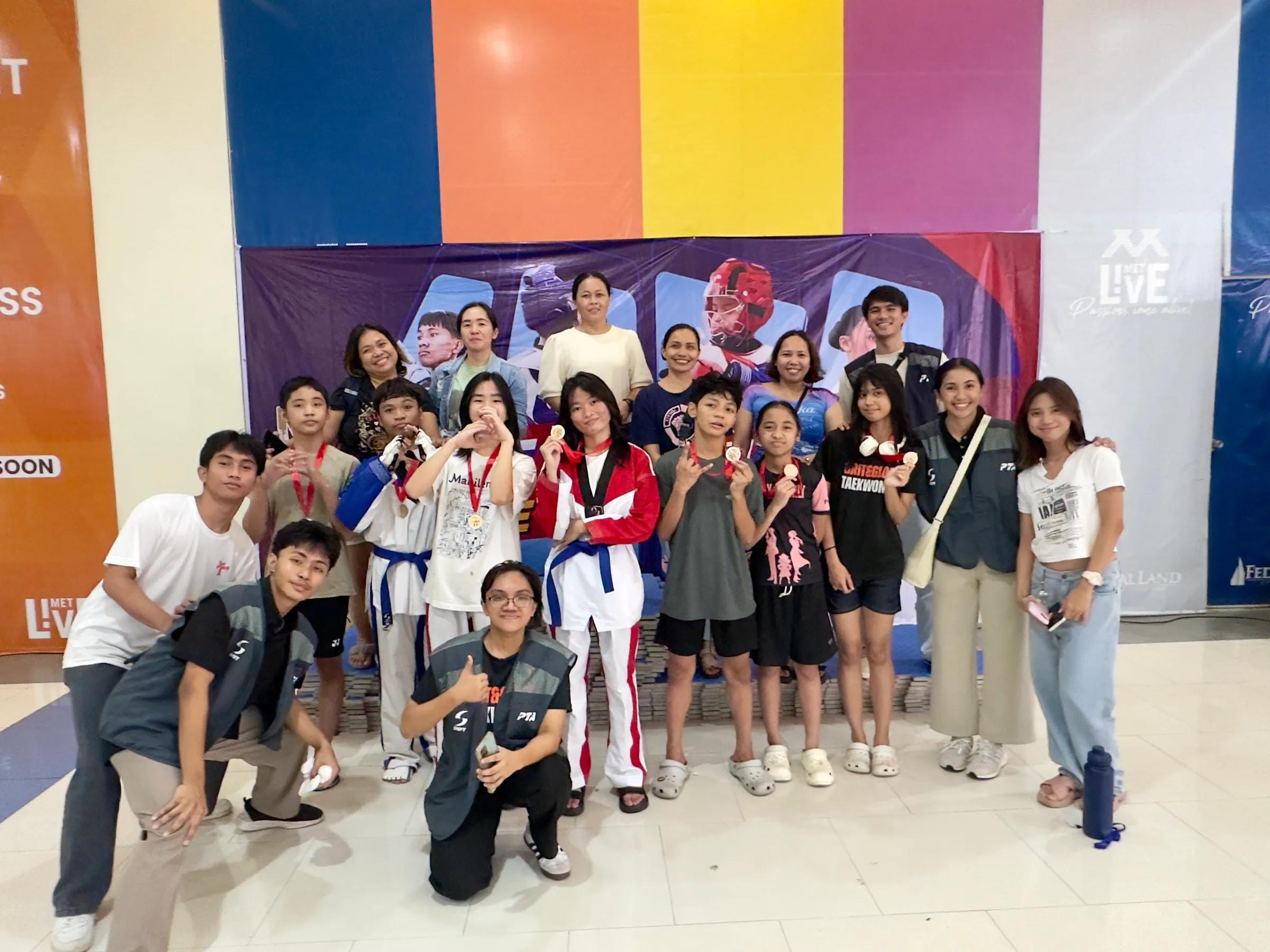 A group of young Grit & Glory students and coaches posing together at an event