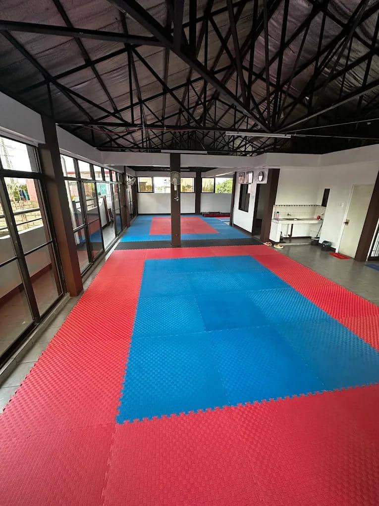 The Hagonoy training floor under an open-air steel-roof hall